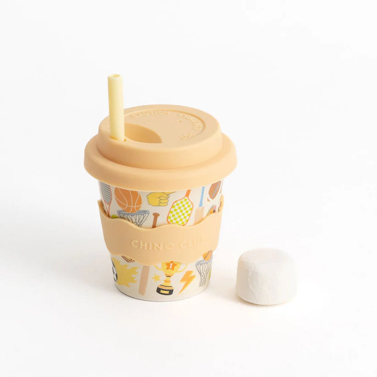 Reusable cup with a patterned sleeve and straw on a white background