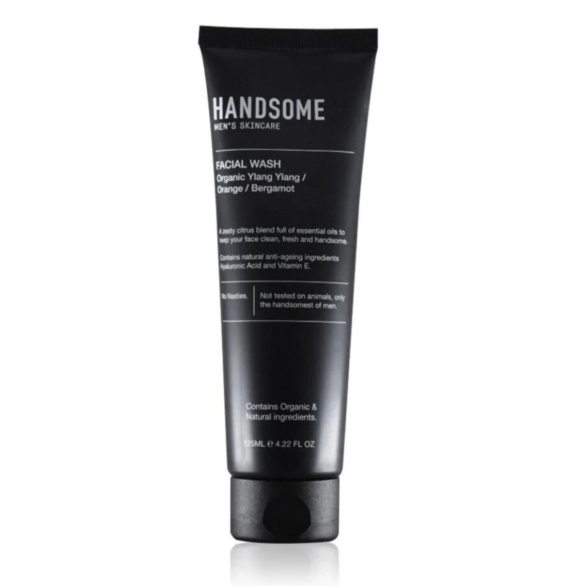Man holding 'HANDSOME' skincare products in a bathroom setting