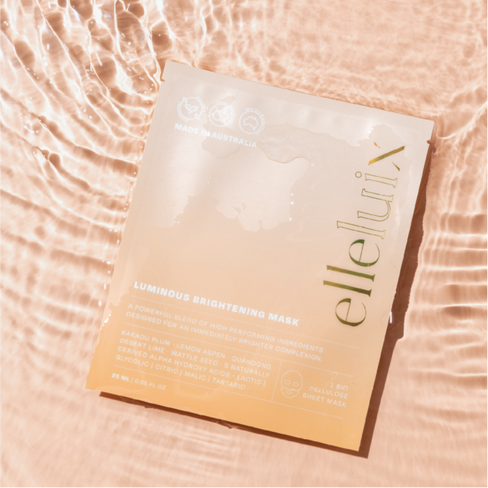 Elle Lux Luminous Brightening Mask on a textured pink background