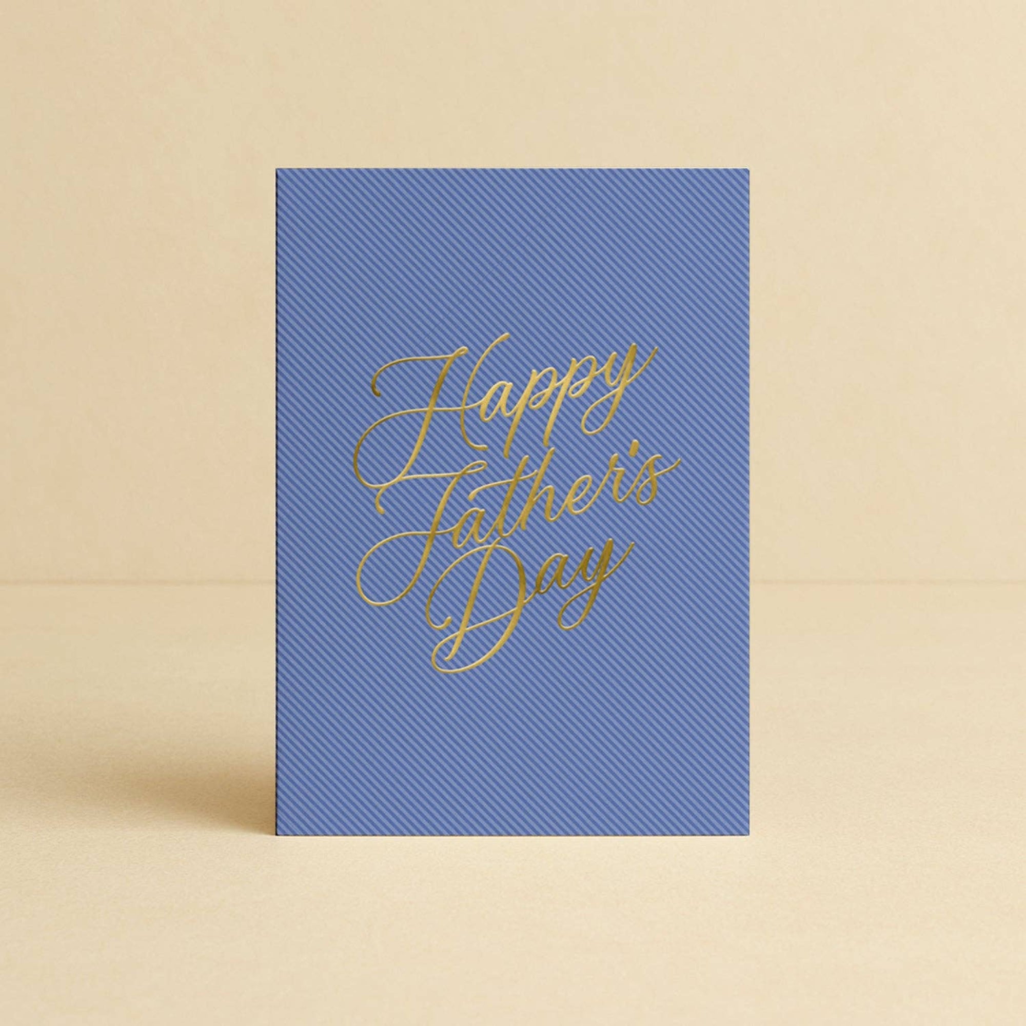 Blue card with 'Happy Father's Day' in gold on a beige background