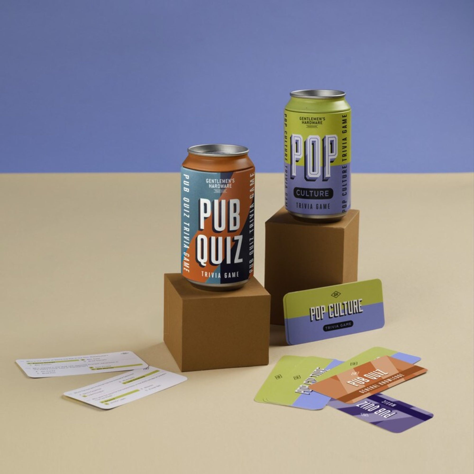 Two cans labeled 'Pub Quiz' and 'Pop Culture' with cards on a beige and blue background