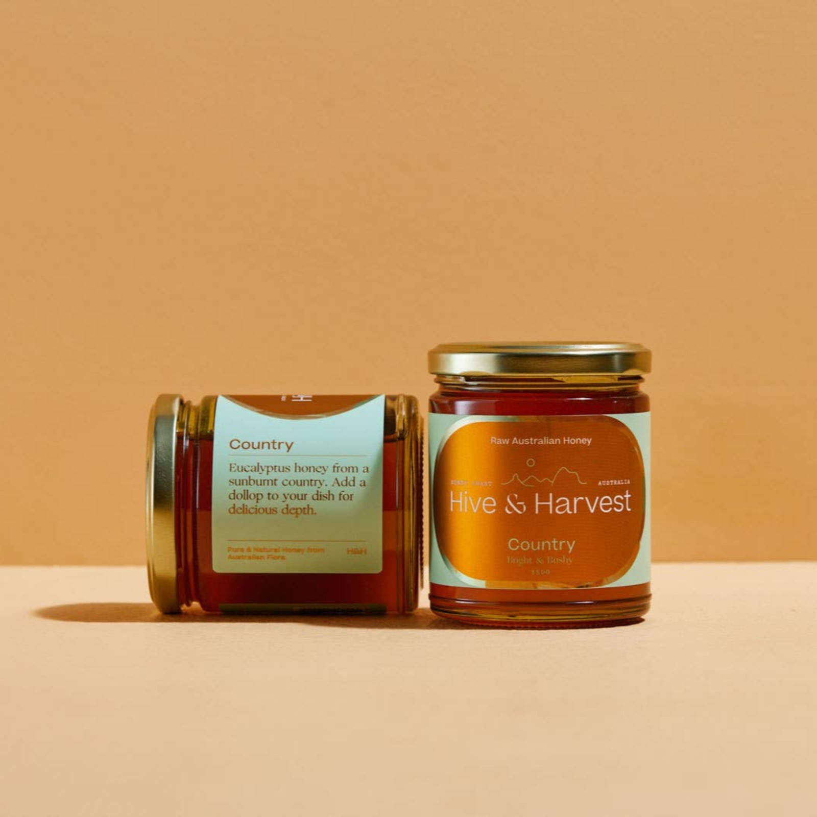 Jar of honey from 'Hive & Harvest' on a beige background