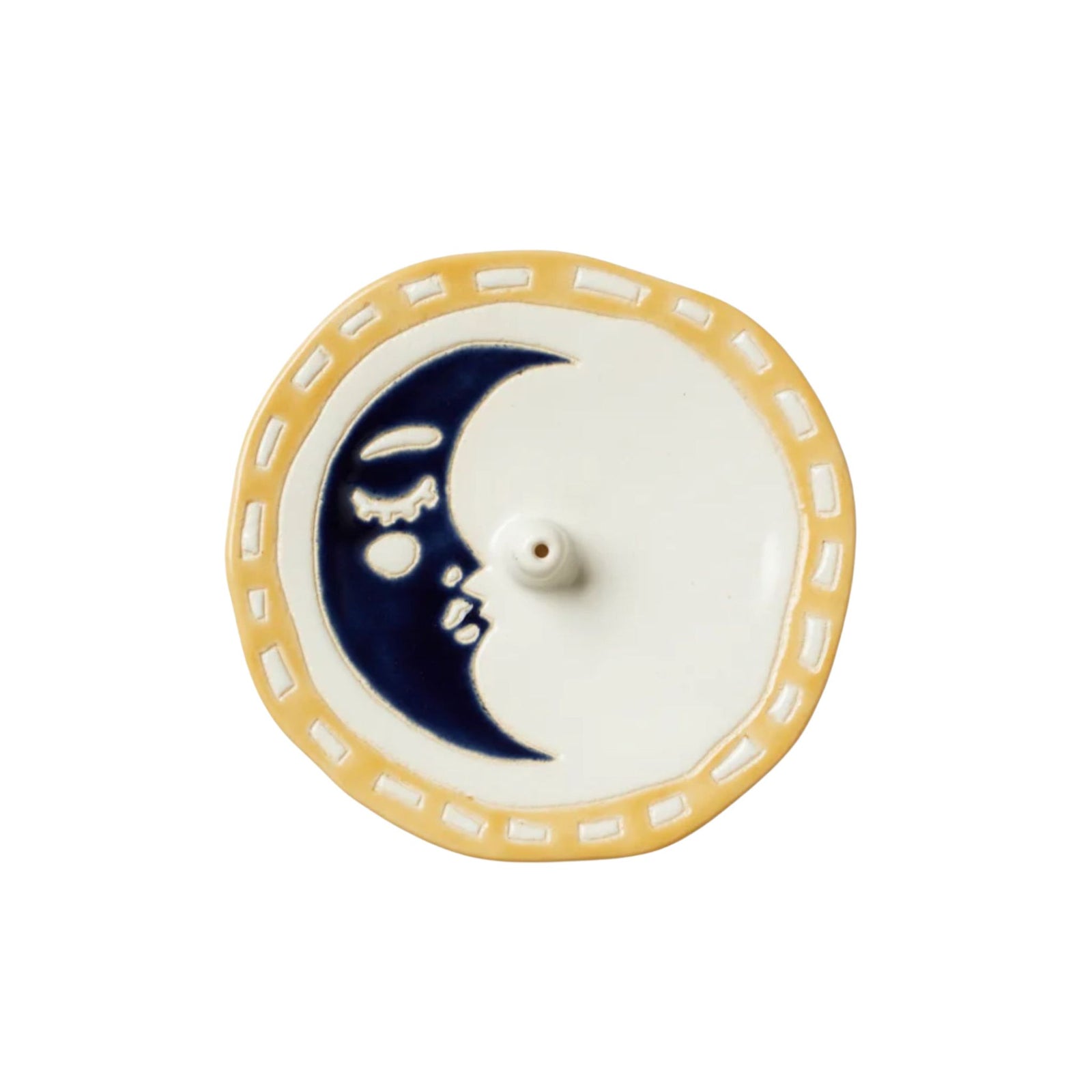 Hand placing a incense stick on a small plate with a white background