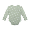 Green baby onesie with white pattern on a white background