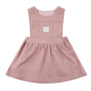 Pink children&#39;s dress with a brand label on a white background