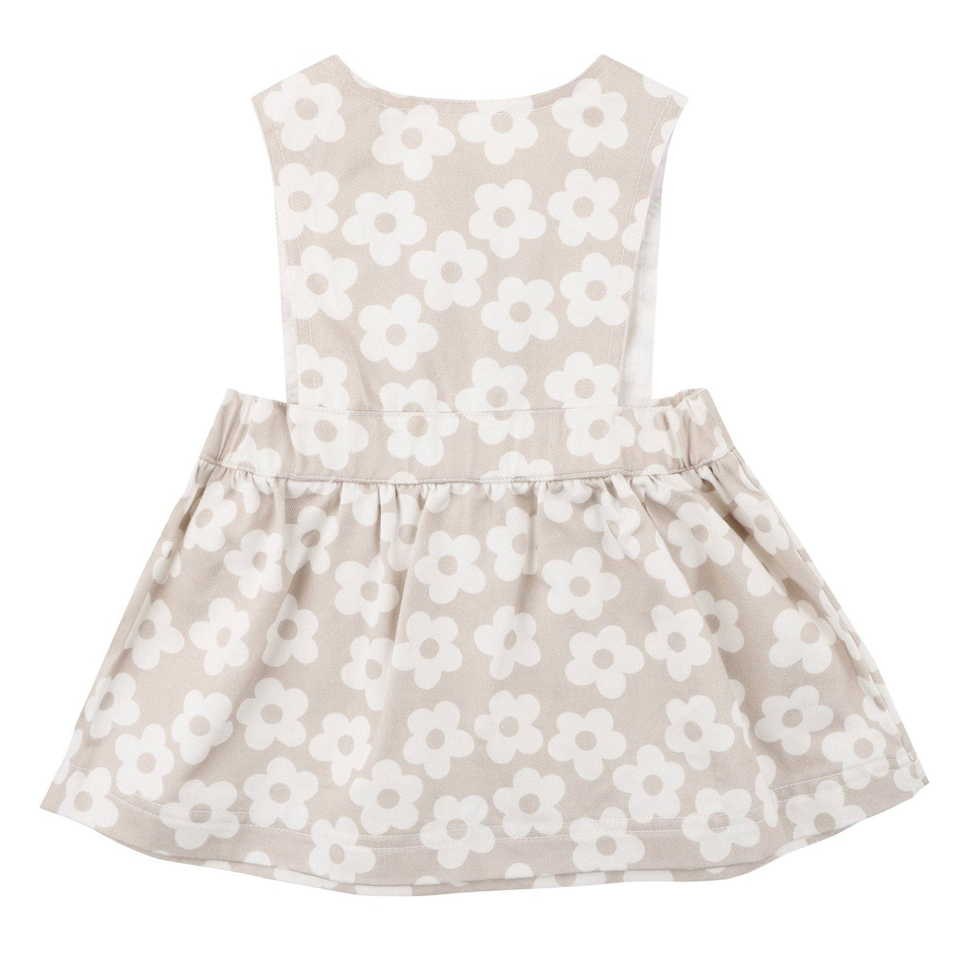 Beige dress with white floral pattern on a white background