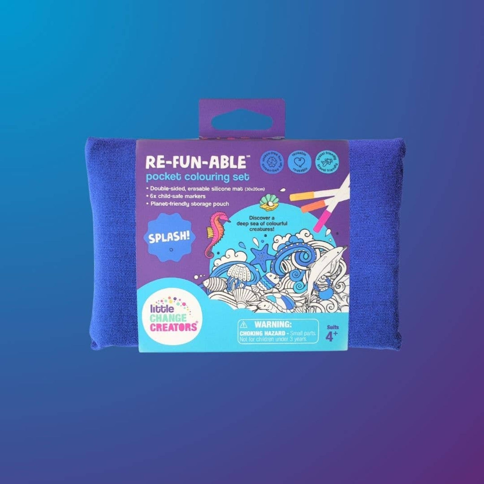 Coloring book with 'Splash!' design, markers, and a towel on a blue gradient background.