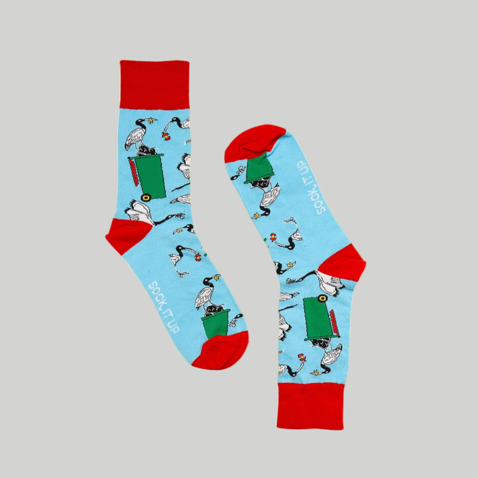 A pair of brightly colored socks with a playful animal and object design, primarily in blue and red colors.