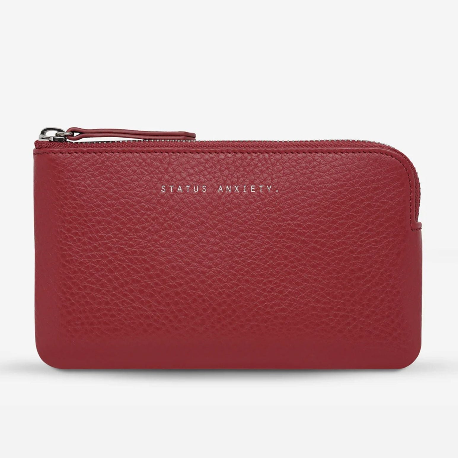 Red wallet with 'Status Anxiety' branding on a light gray background
